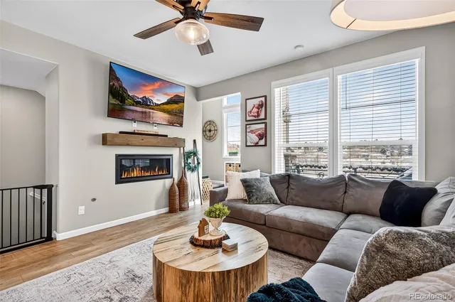 a living room with furniture a fireplace and a flat screen tv