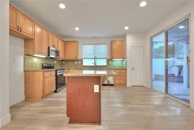 a view of kitchen and kitchen with furniture wooden floor and window