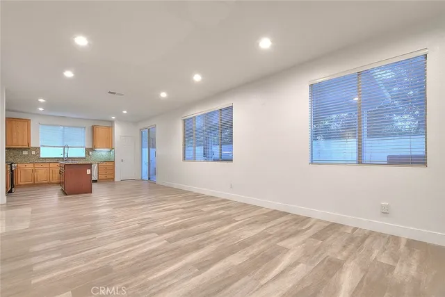a kitchen with stainless steel appliances granite countertop a sink and a refrigerator
