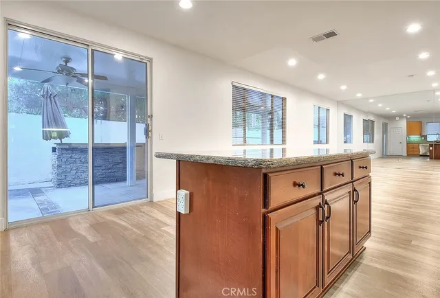 a kitchen with stainless steel appliances granite countertop a stove sink and cabinets