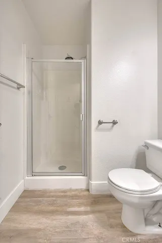 a spacious bathroom with a granite countertop sink a mirror and a shower
