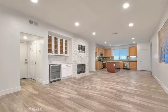 a view of a kitchen with a sink and a refrigerator