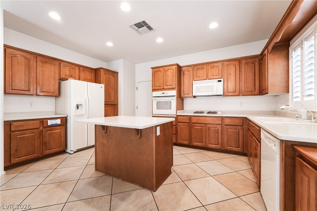 3033 Hartsville Road Henderson, NV 89052 - Photo 20 of 41 A well-appointed kitchen showcases ample cabinetry, a central island, and modern appliances.