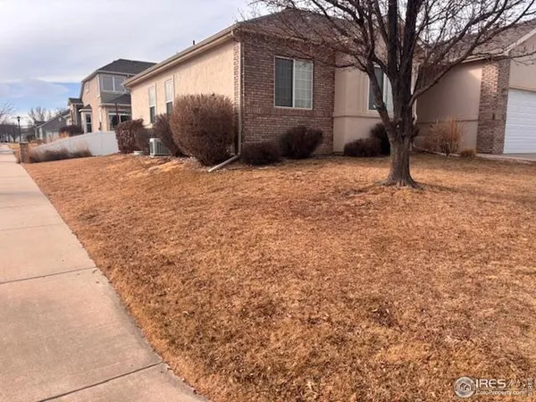 a view of a house with a yard covered in snow