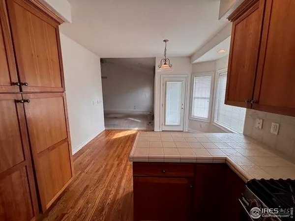 a view of hallway with wooden floor