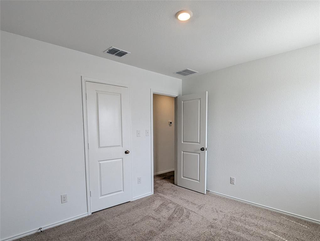 152 Avre Loop Kyle, TX 78640 - Photo 21 of 24 An inviting room features plush carpeting and recessed lighting, ready for personalization.