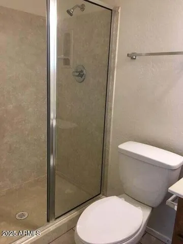 a white toilet sitting next to a bathroom sink