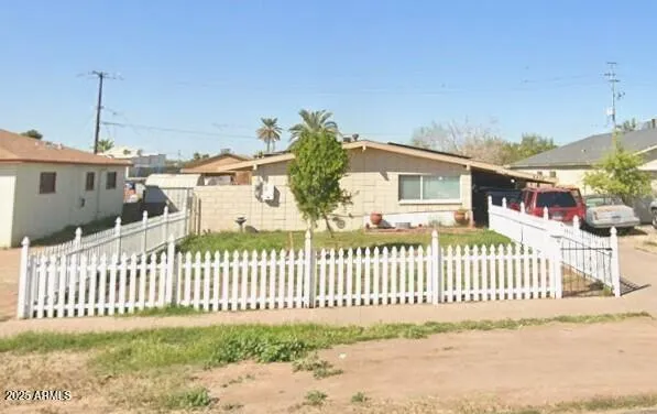 a view of a house with a fence