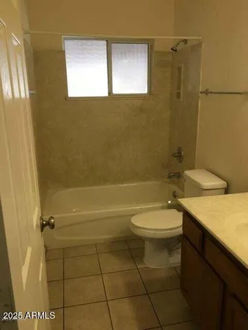 a bathroom with a granite countertop toilet a sink and a shower