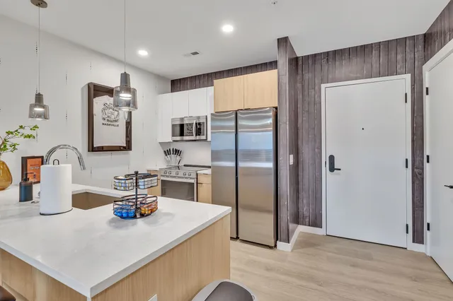 a kitchen with a refrigerator a sink and cabinets