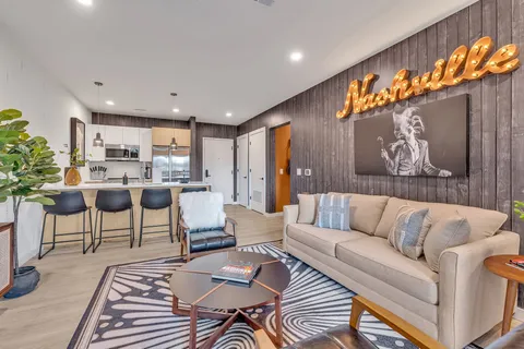 a living room with furniture and a chandelier