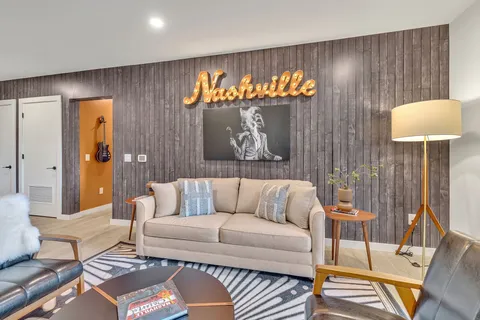 a living room with furniture and a lamp