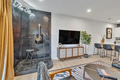 a living room with furniture and a flat screen tv