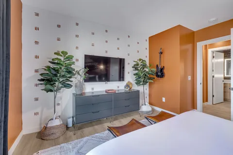 a bedroom with a bed and a flat screen tv