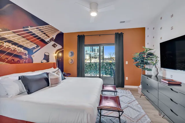 a bedroom with a bed and a flat screen tv