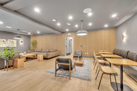 a front view of building with outdoor seating and city view