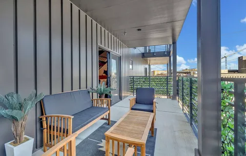 a balcony with furniture and potted plants