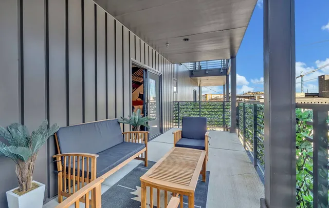 a balcony with furniture and potted plants