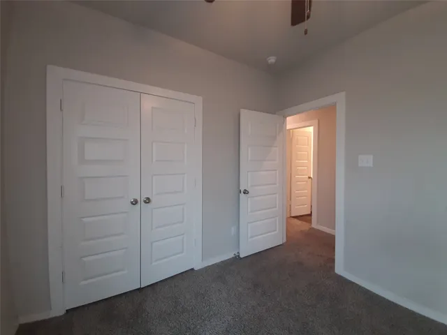 a view of an empty room and closet area