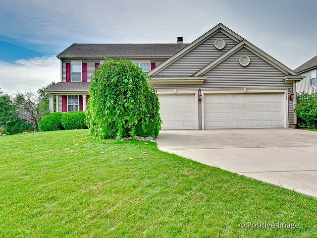 1463 Saddleridge Place Bartlett, IL 60103 - Photo 2 of 27 a front view of a house with garden