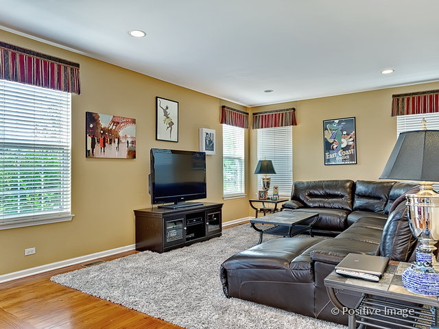 1463 Saddleridge Place Bartlett, IL 60103 - Photo 13 of 27 a living room with furniture and a flat screen tv
