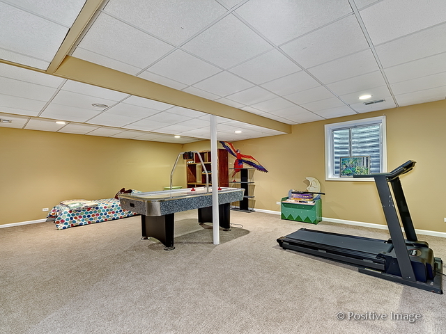 1463 Saddleridge Place Bartlett, IL 60103 - Photo 24 of 27 a room with furniture and air hockey table