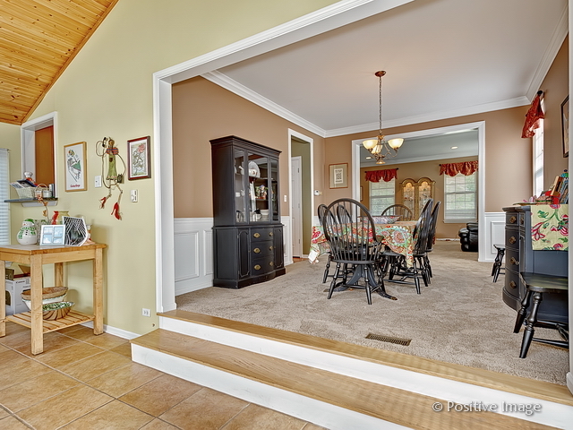 1463 Saddleridge Place Bartlett, IL 60103 - Photo 9 of 27 a work room with furniture and a chandelier