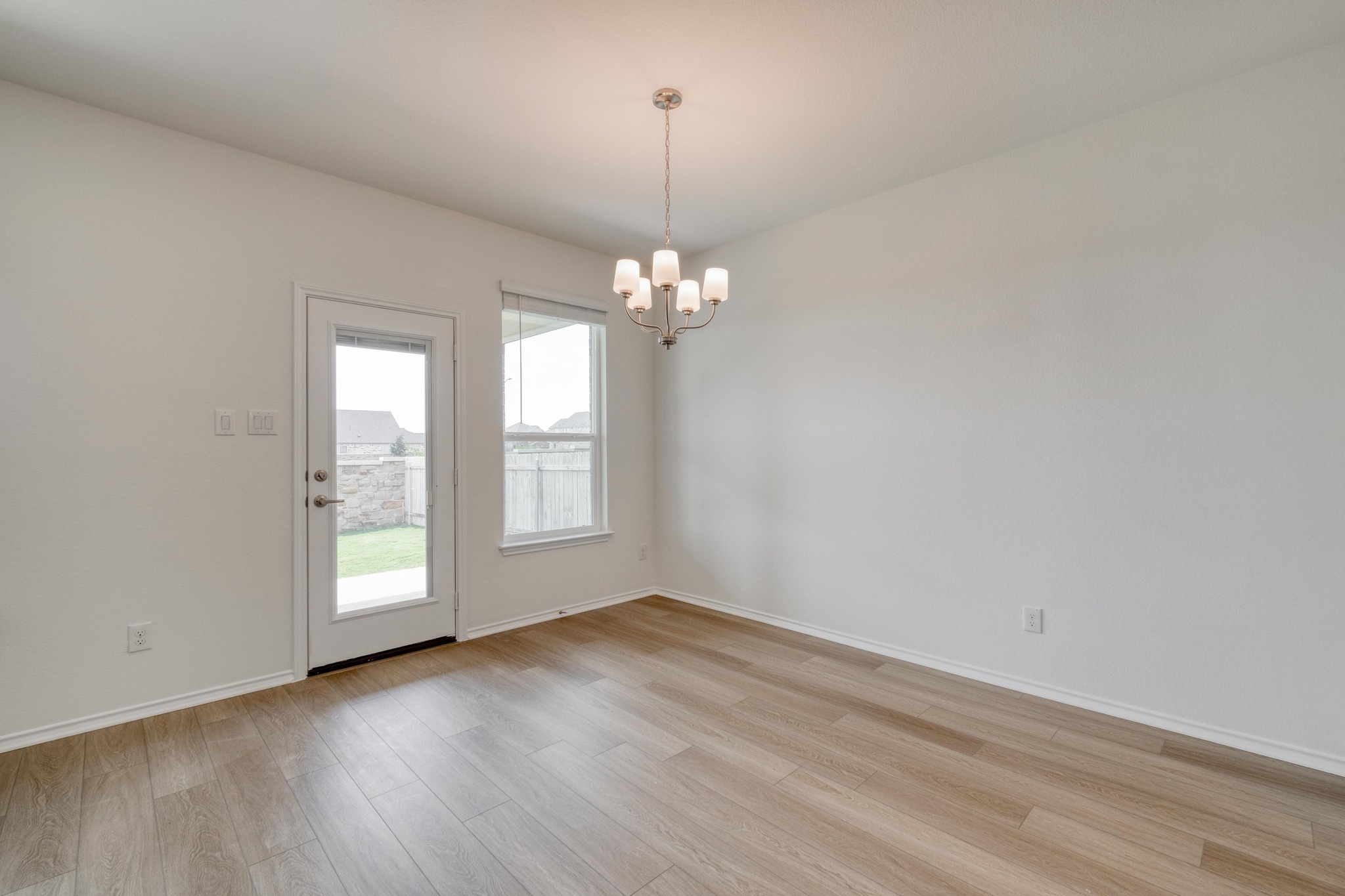4608 Centola Loop Round Rock, TX 78665 - Photo 12 of 33 wooden floor in an empty room with a window