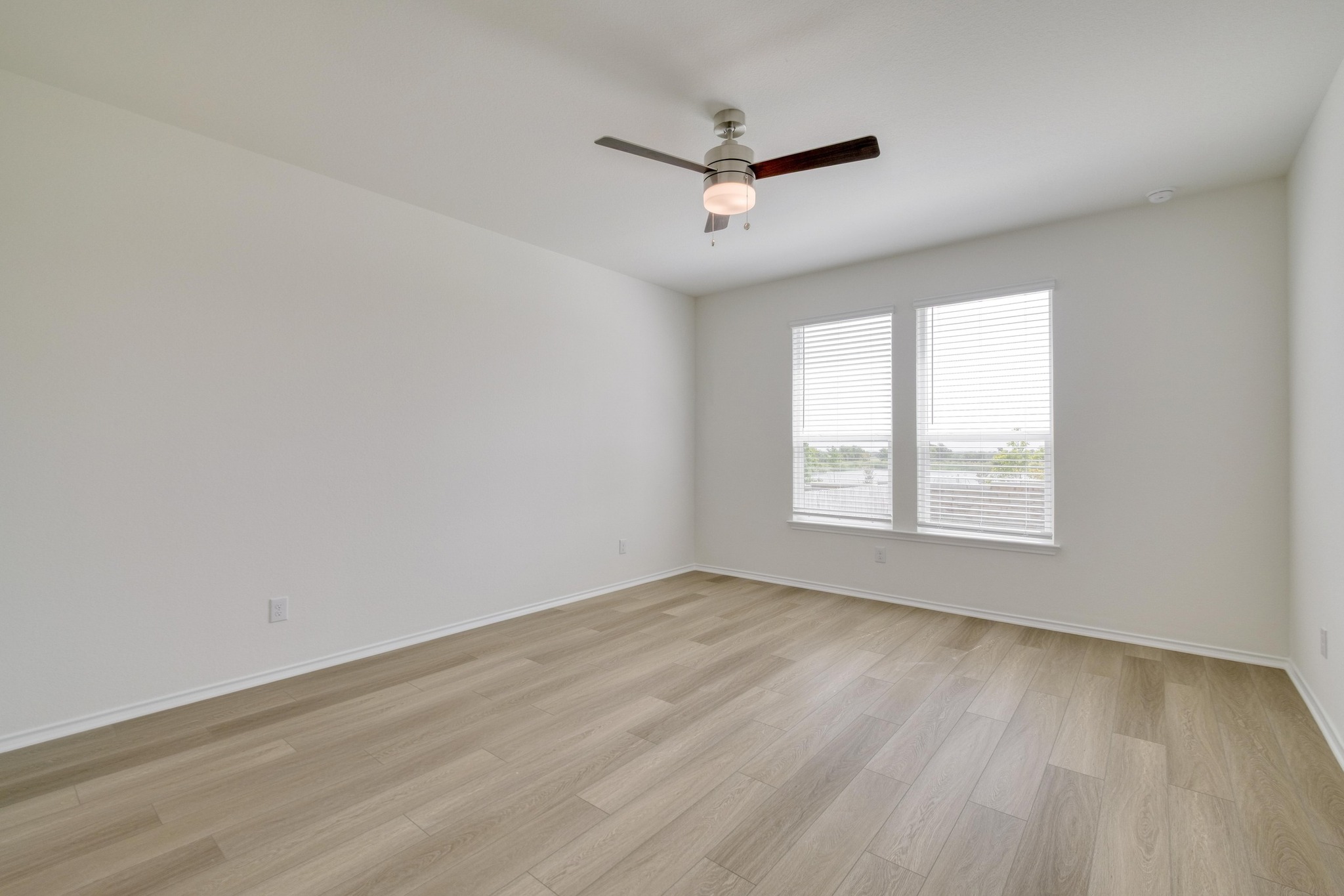 4608 Centola Loop Round Rock, TX 78665 - Photo 14 of 33 an empty room with wooden floor ceiling fan and windows