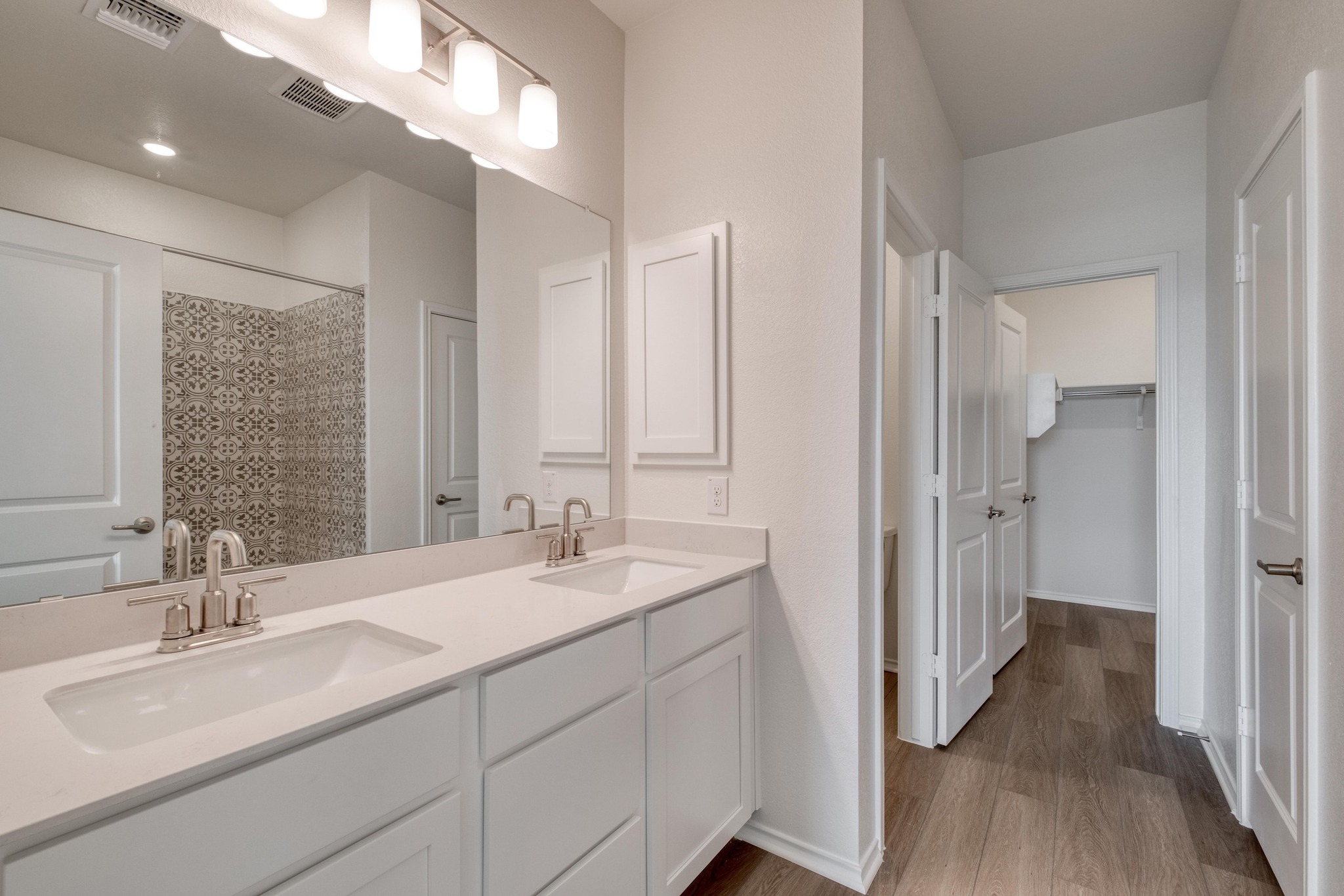 4608 Centola Loop Round Rock, TX 78665 - Photo 16 of 33 a en suite bathroom with a double vanity sink and mirror