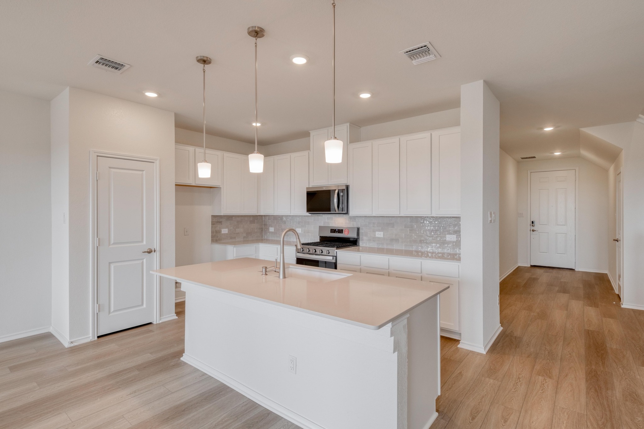 4608 Centola Loop Round Rock, TX 78665 - Photo 6 of 33 a kitchen with a sink a counter top space stainless steel appliances and a window