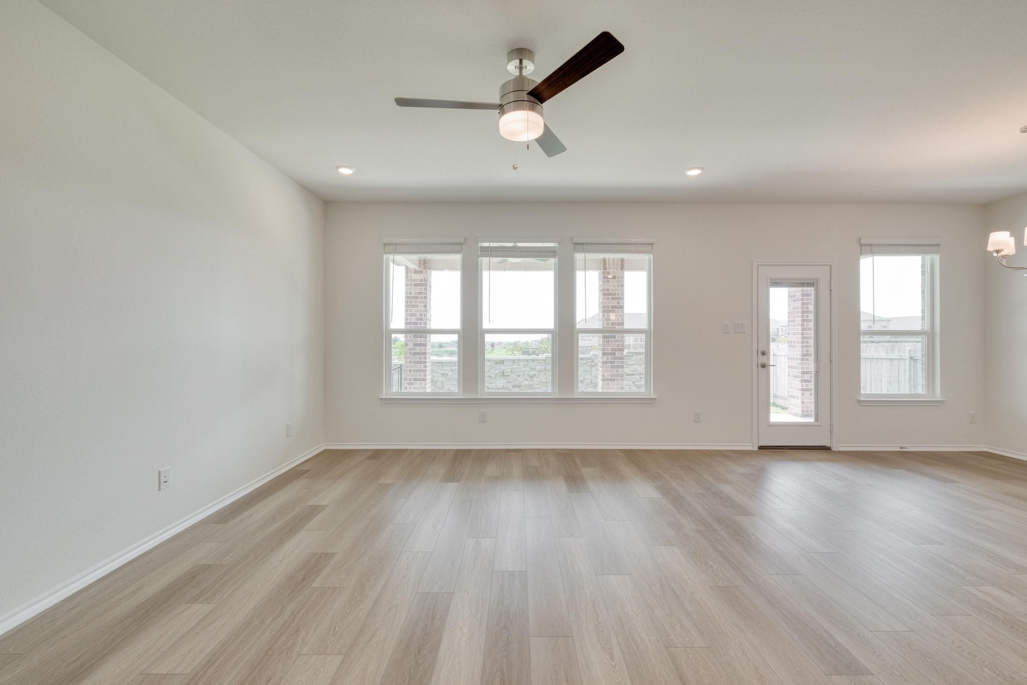4608 Centola Loop Round Rock, TX 78665 - Photo 10 of 33 an empty room with wooden floor and windows