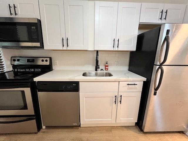1000 Southwest 12th Court, Unit 4 Miami, FL 33135 - Photo 11 of 21 a kitchen with stainless steel appliances a refrigerator stove and white cabinets