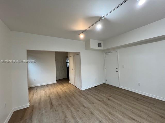 1000 Southwest 12th Court, Unit 4 Miami, FL 33135 - Photo 18 of 21 an empty room with wooden floor and windows