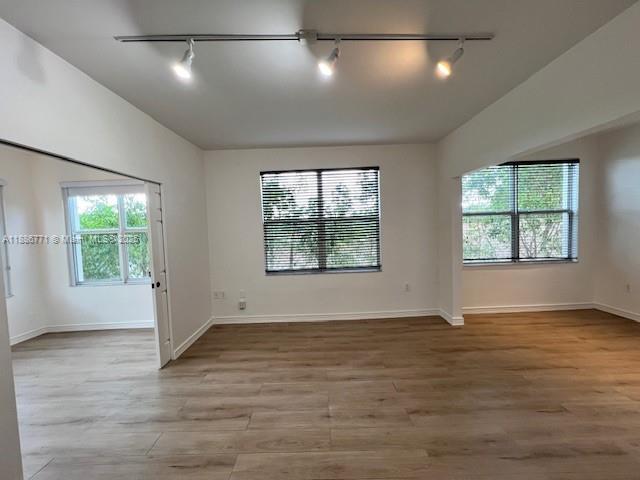 1000 Southwest 12th Court, Unit 4 Miami, FL 33135 - Photo 2 of 21 an empty room with wooden floor and windows