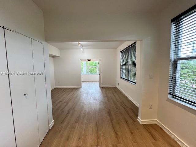 1000 Southwest 12th Court, Unit 4 Miami, FL 33135 - Photo 4 of 21 a view of an empty room with wooden floor and a window