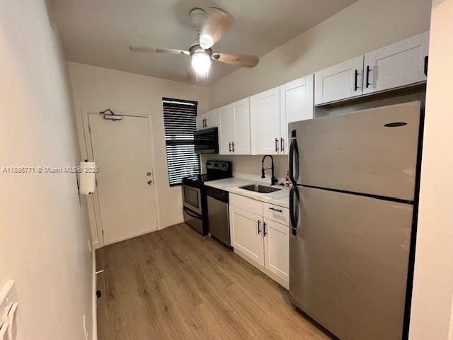 1000 Southwest 12th Court, Unit 4 Miami, FL 33135 - Photo 10 of 21 a kitchen with stainless steel appliances a refrigerator a stove a sink and white cabinets