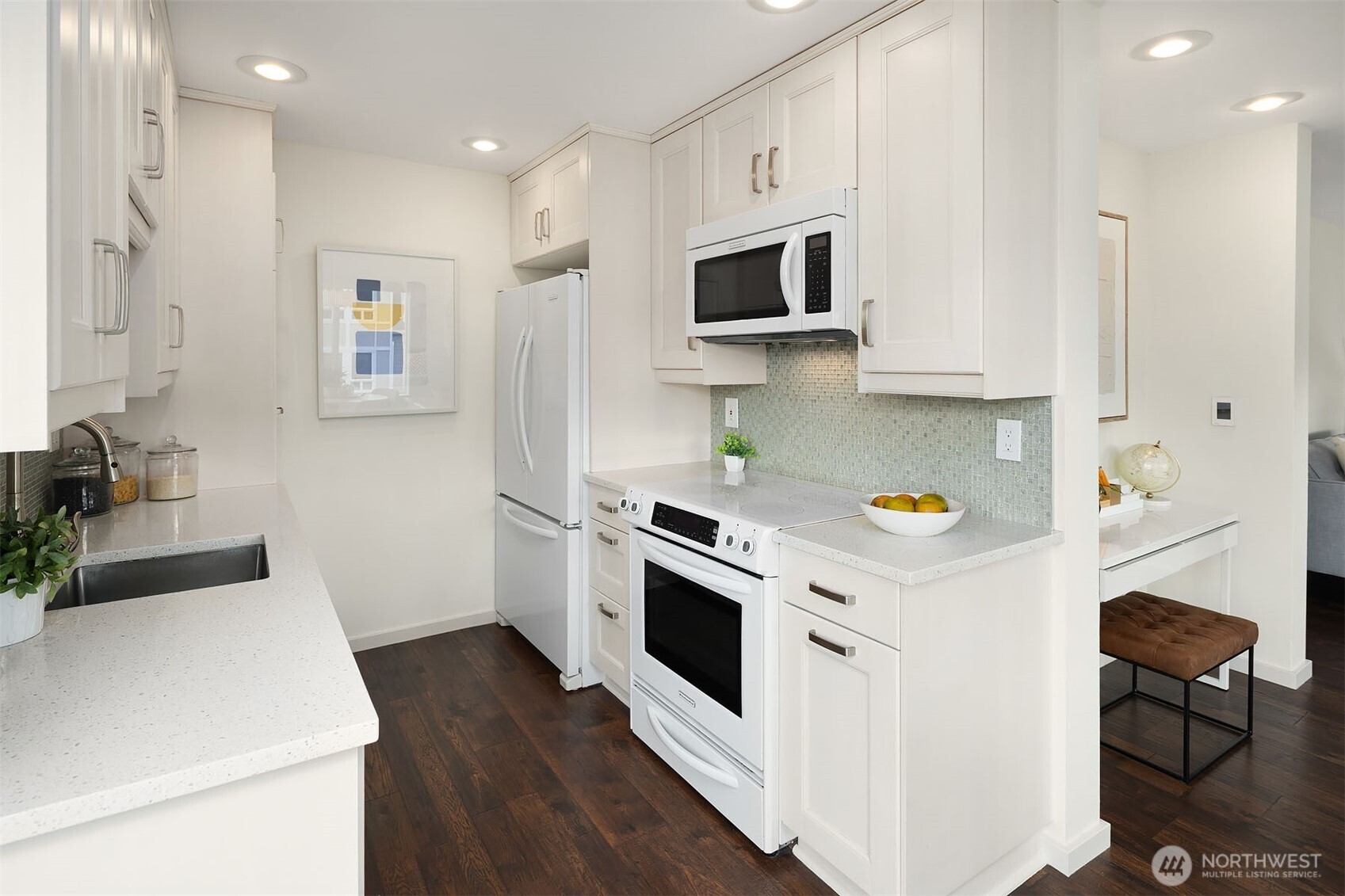 500 Aloha Street, Unit E307 Seattle, WA 98109 - Photo 14 of 28 a kitchen with stainless steel appliances a stove a microwave a sink a refrigerator white cabinets and wooden floor