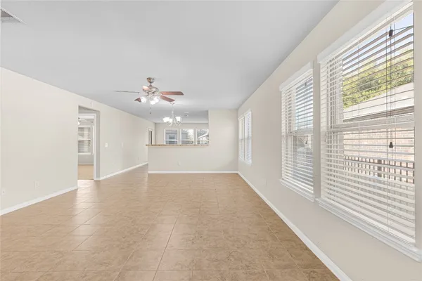 a view of a livingroom with a ceiling fan and window