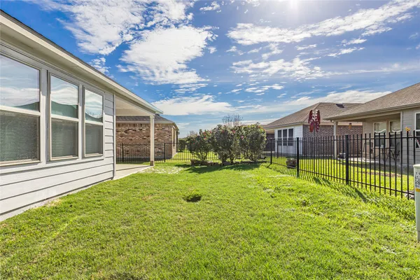 a view of a house with backyard and porch