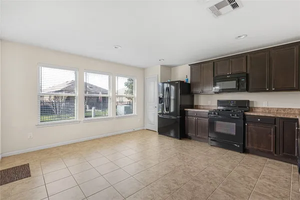 a kitchen with stainless steel appliances granite countertop a refrigerator and a stove