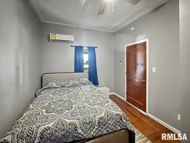 a bed sitting in a spacious bedroom next to a bathroom