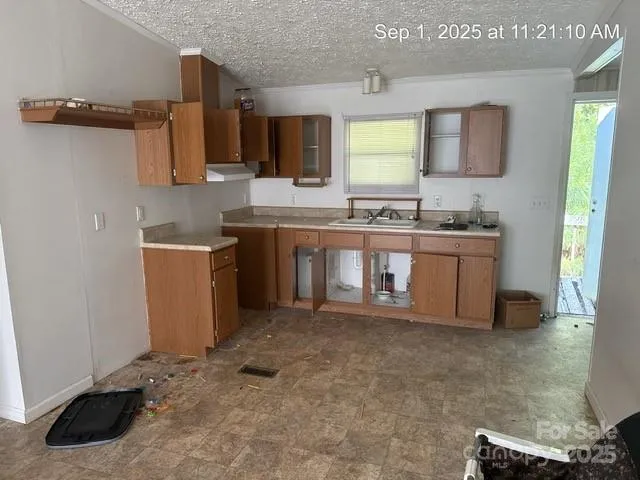 a large kitchen with stainless steel appliances granite countertop a sink and a stove