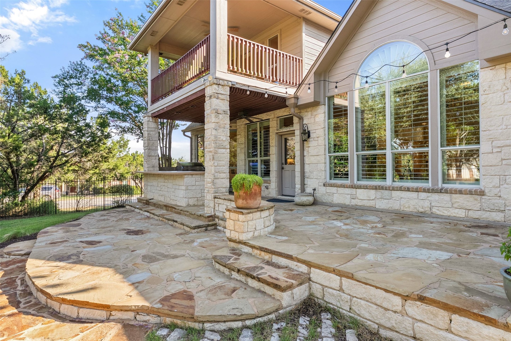 8215 Dark Ridge Cove Austin, TX 78737 - Photo 33 of 40 An expansive stone patio spans the back of the home, an includes a covered outdoor kitchen, perfect for entertaining.