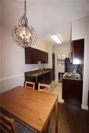 a kitchen with stainless steel appliances granite countertop a stove refrigerator sink and microwave
