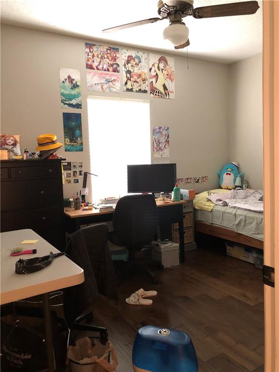 203 East 31st Street, Unit 103 Austin, TX 78705 - Photo 16 of 32 a bedroom with furniture and a wooden floor