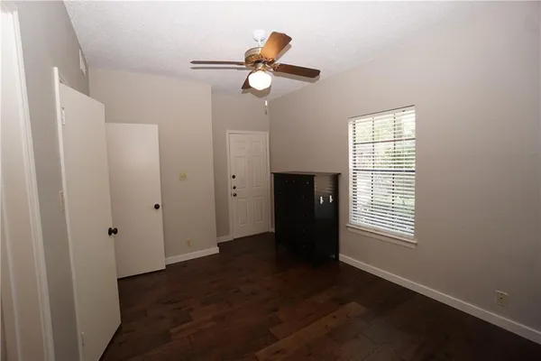 an empty room with wooden floor and closet