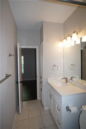 an empty room with a window and a ceiling fan