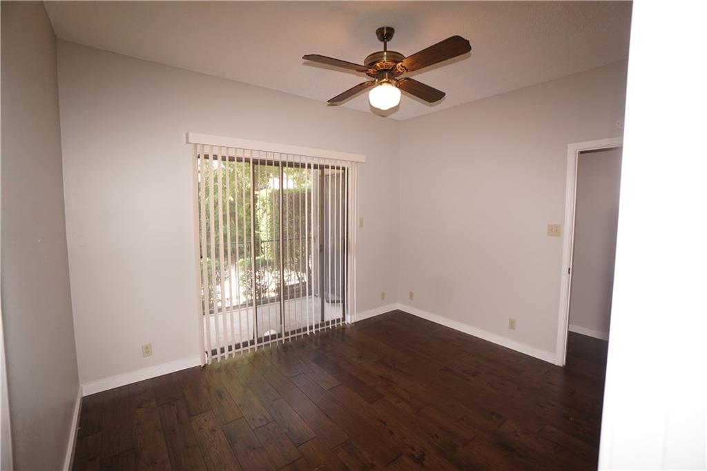 203 East 31st Street, Unit 103 Austin, TX 78705 - Photo 23 of 32 an empty room with wooden floor and windows