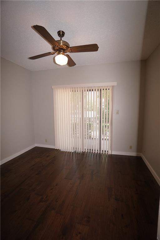 203 East 31st Street, Unit 103 Austin, TX 78705 - Photo 24 of 32 a view of wooden floor and a chandelier fan in a room